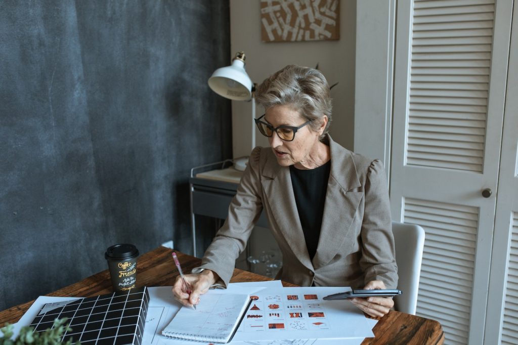 Woman working at desk with plans